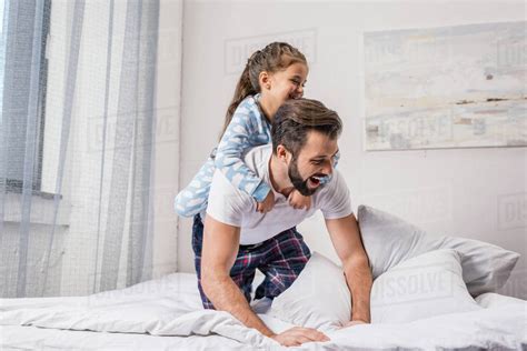 daddyanddaughter|Loving father and cute daughter playing in bed